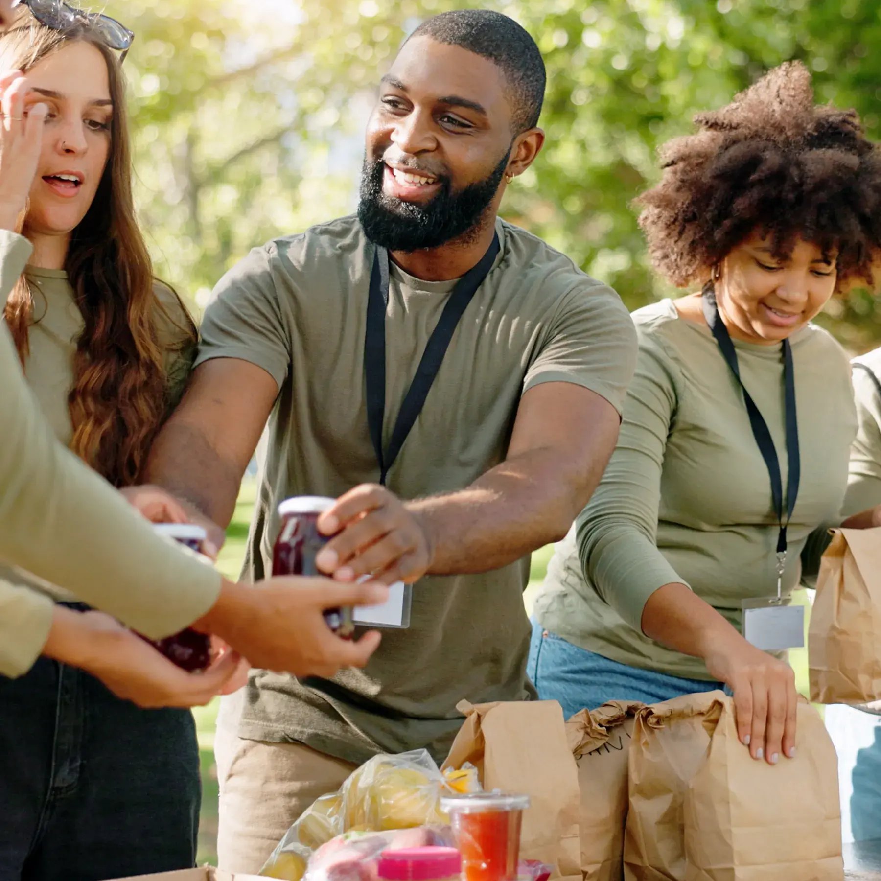 happy-people-volunteer-food-with-bags-charity-community-service-outdoor-park-group-team-working-together-ngo-with-resources-supplies-mission-future-giving-nature