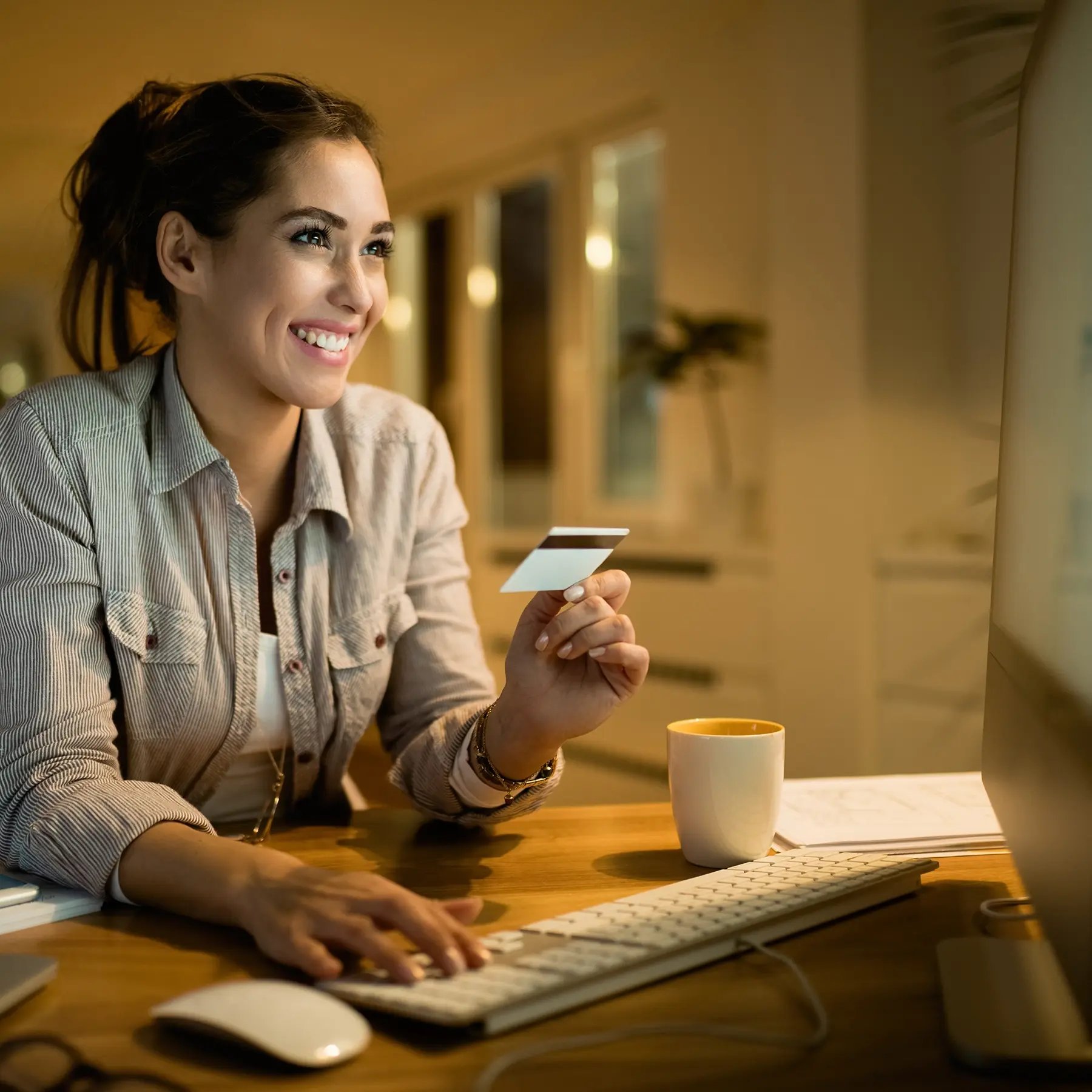 young-happy-woman-using-credit-card-online-shopping-evening-home
