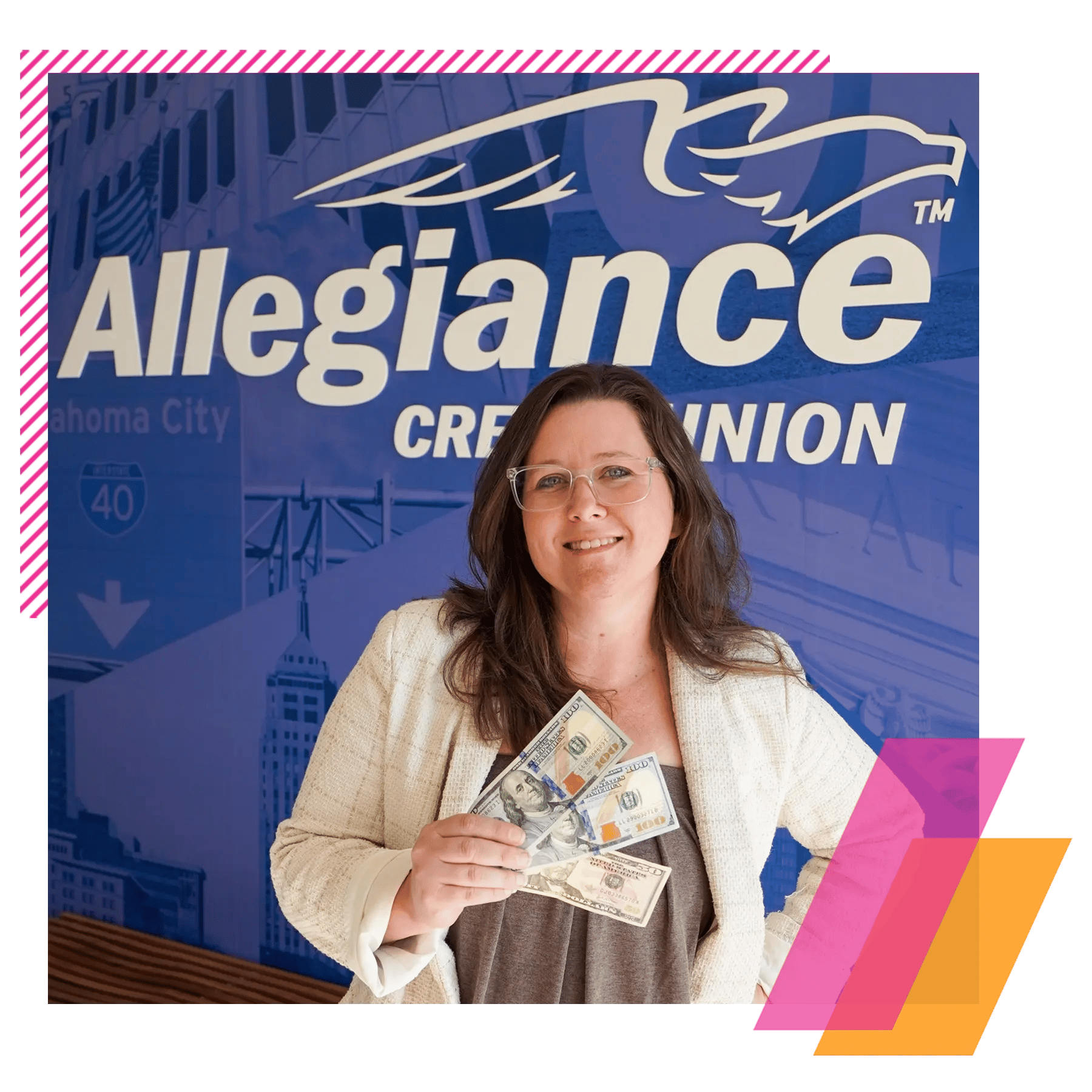 Woman holding cash in front of blue Allegiance Credit Union logo