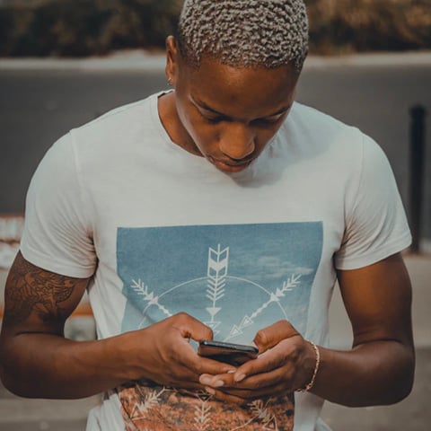 man in white shirt on phone