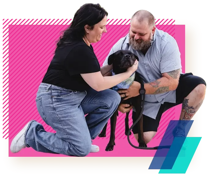 Two Allegiance members with their dog.