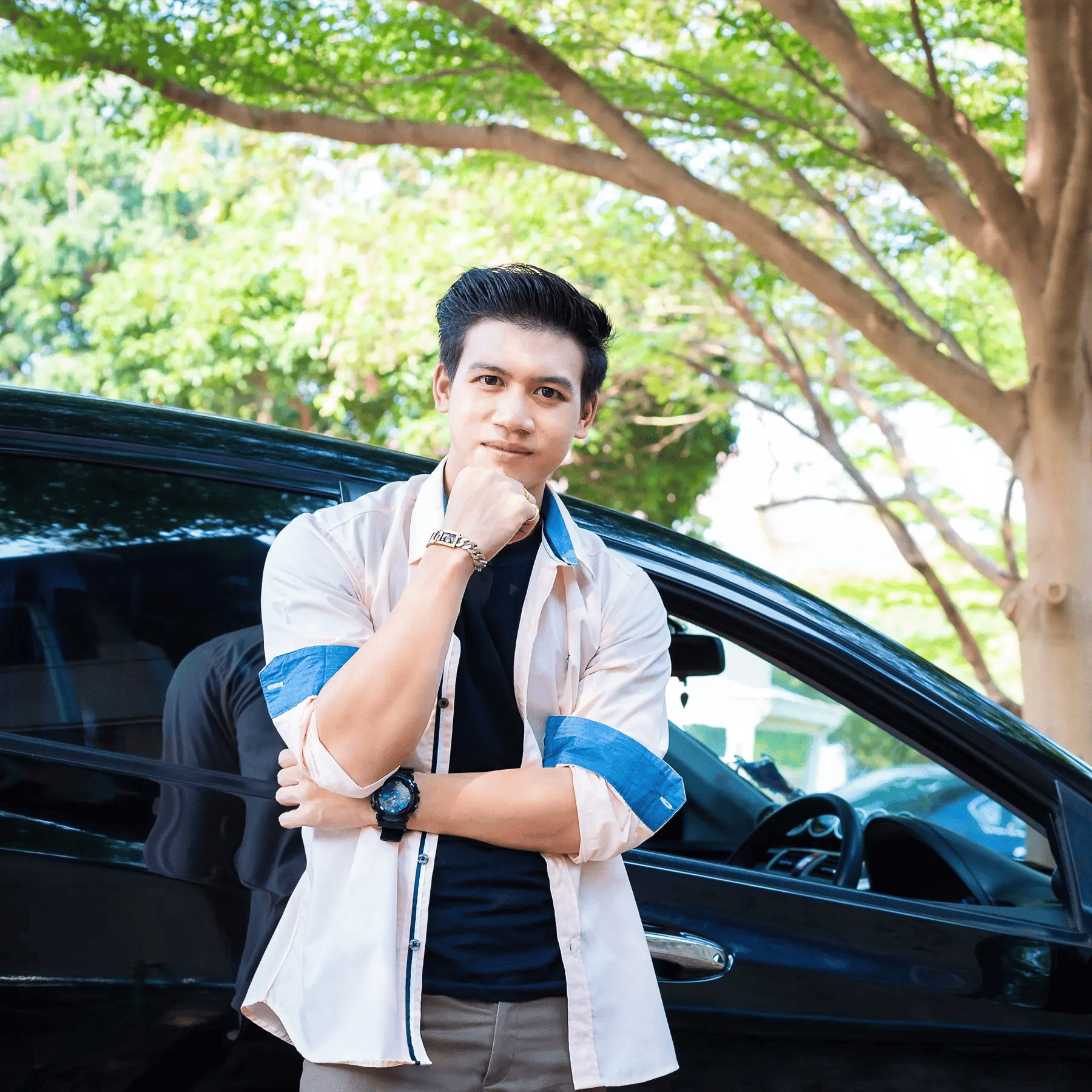 Young asian man standing by his new car purchased with a first time car buyer loan from Allegiance.