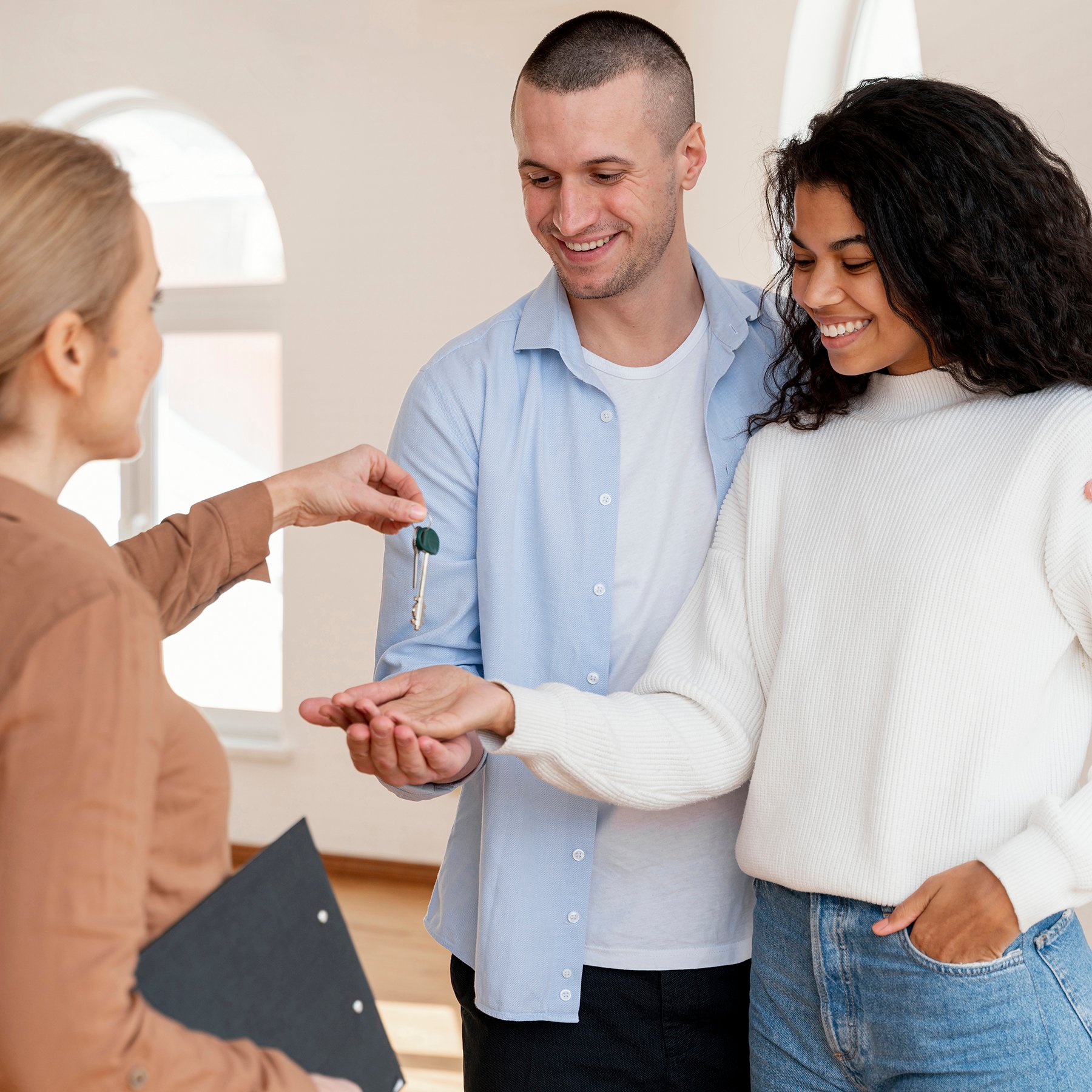 realtor-handing-smiley-couple-keys-their-new-home