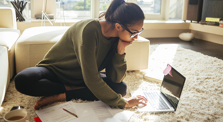 women reviewing paperwork and laptop