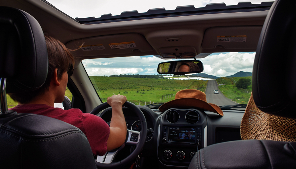 Refinancing your car is possible so you can enjoy the ride with the sunroof open like this man.