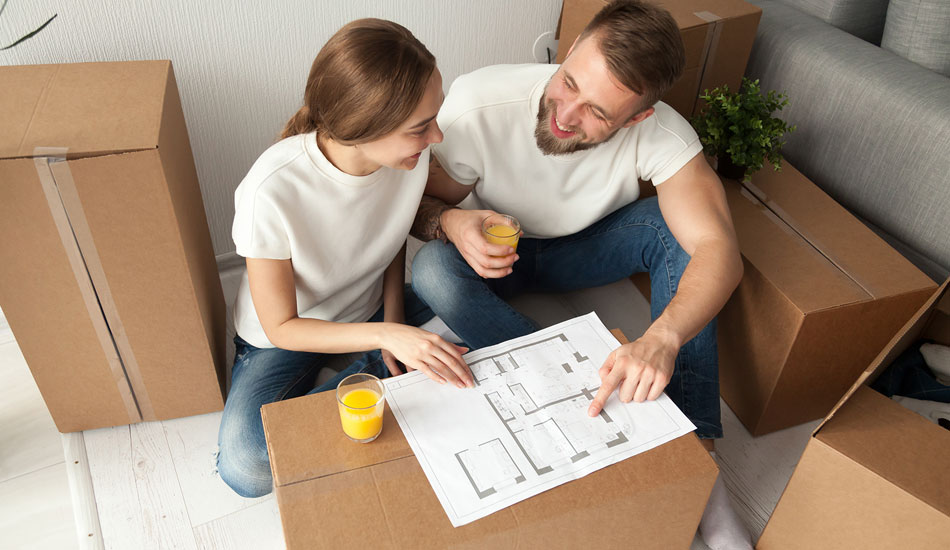 Couple preparing a renovation budget which reviewing a house architecture sketch of improvements.