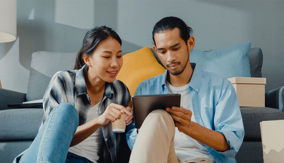 Couple-reviewing-their-credit-score-on-a-tablet-wondering-what-is-a-good-credit-score.