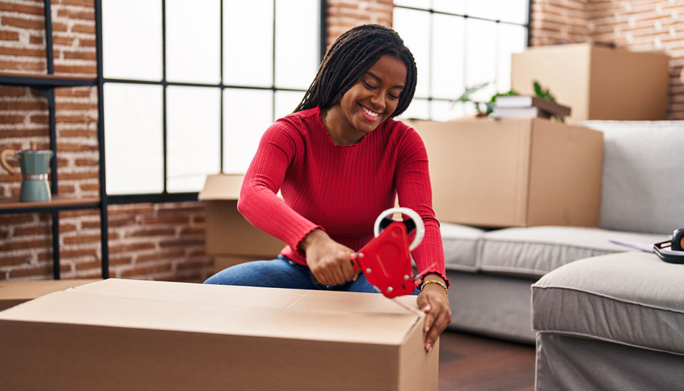 This woman packing up her things was curious what credit score is needed to buy a house but she is moving now.