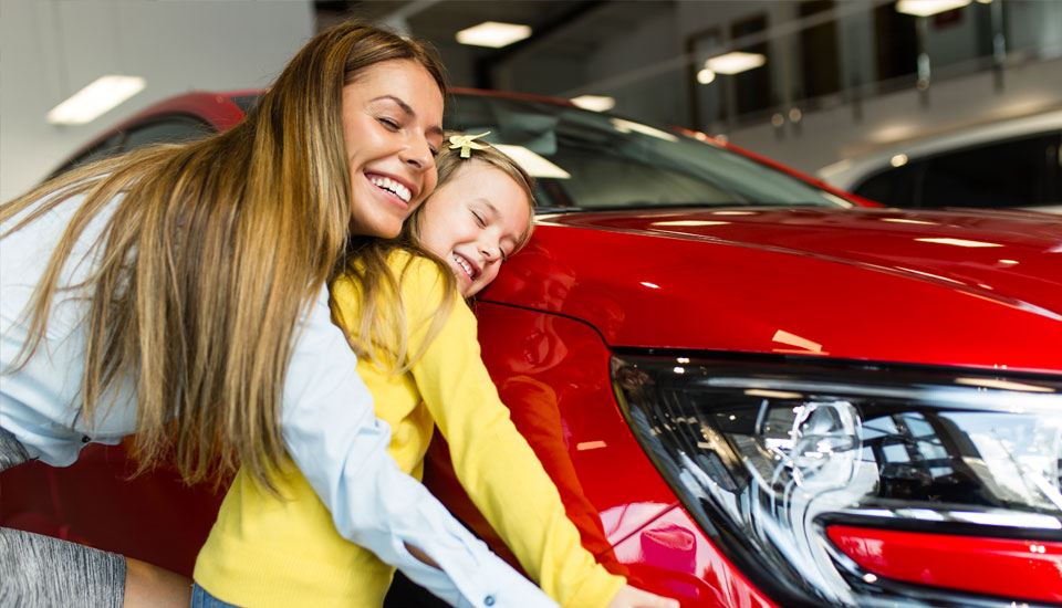 Woman wondered what credit score is needed to buy a car and then successfully bought a new red car with her daughter.