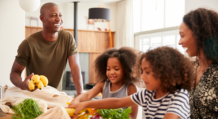 African American Family cutting up vegetables