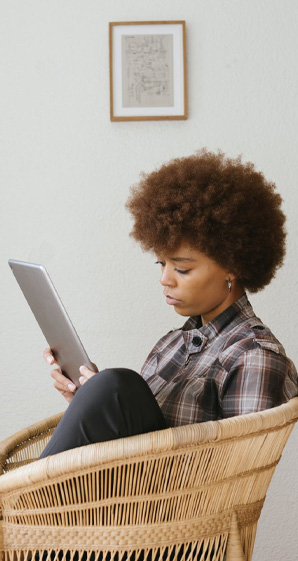 Woman Holding Tablet sitting in chair