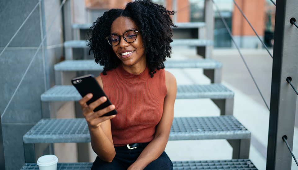 millennial woman reading personal finance tips on phone