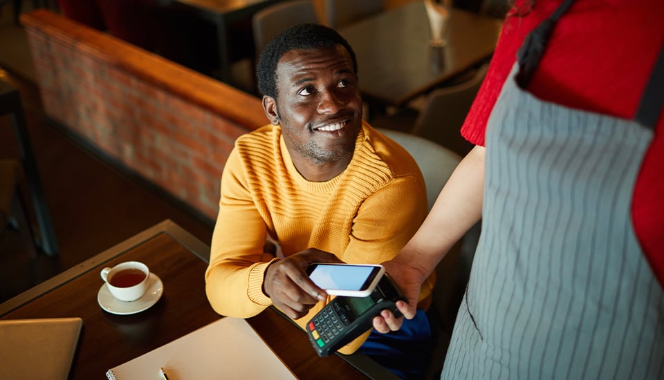 man safely using his phone for a mobile payment