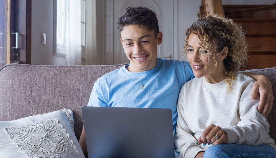 college kid reviewing a list of things he needs to fill out his FAFSA application with his mother