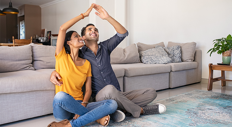 hispanic couple sitting in their living room