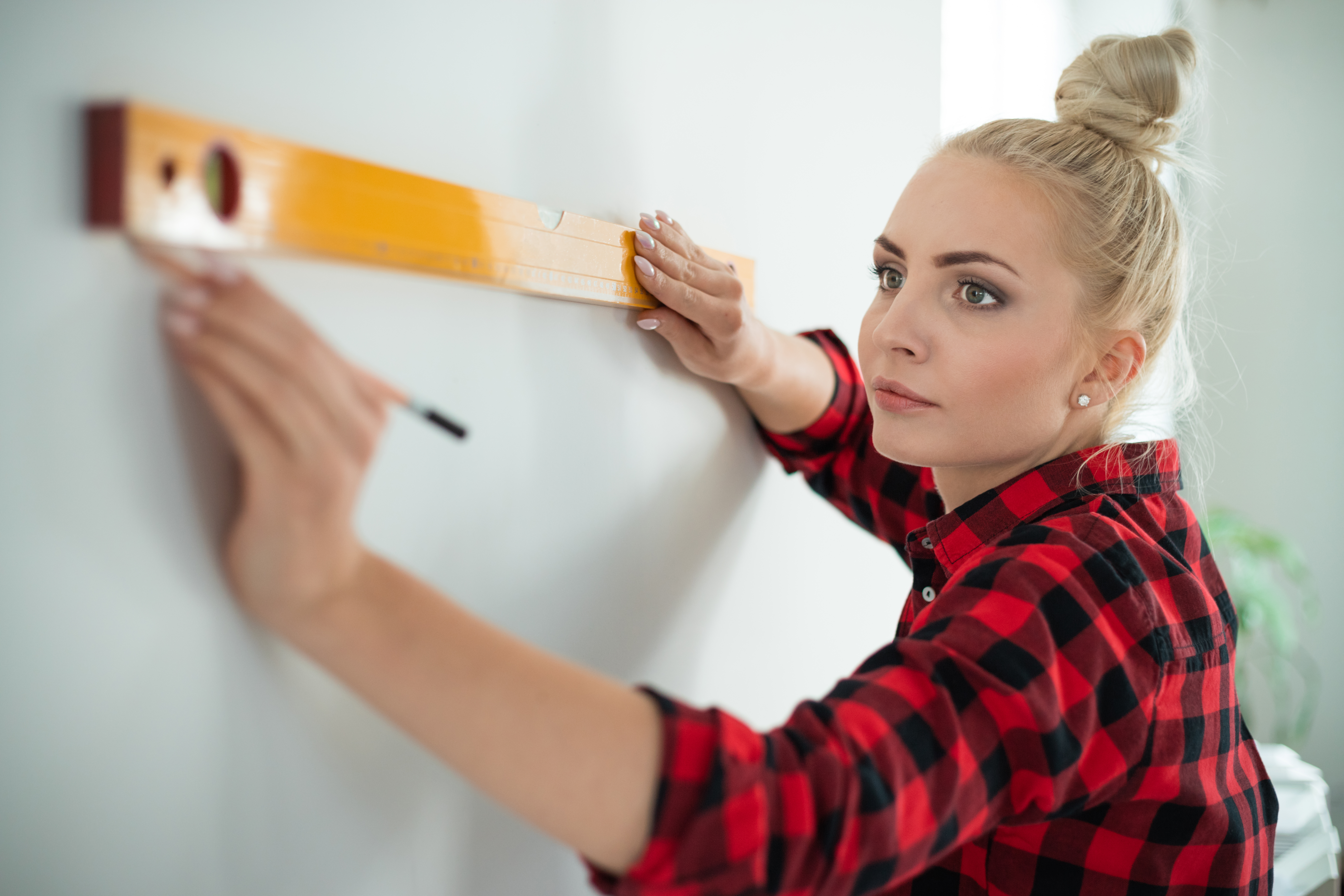 woman using leveling tool at home