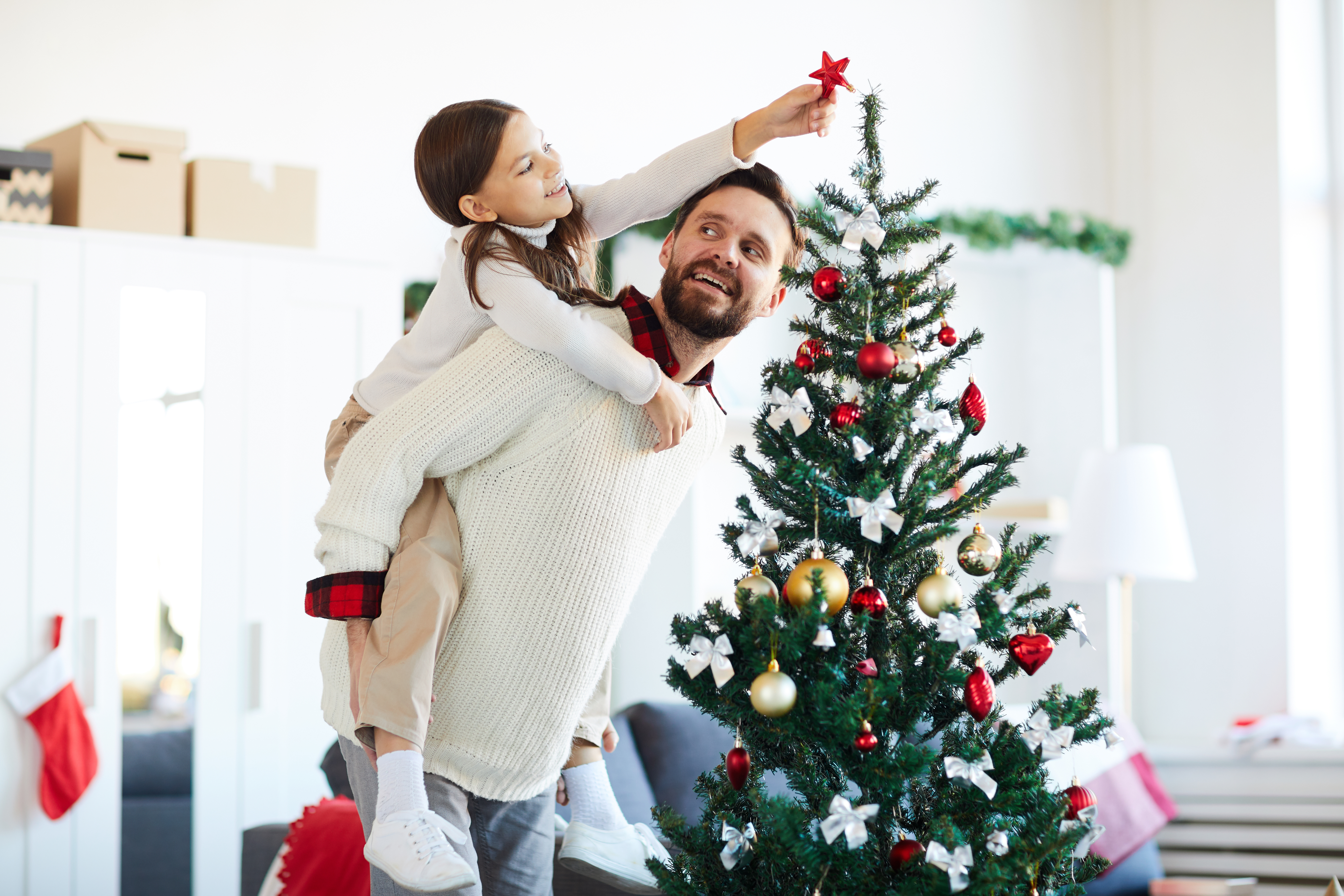 Father and Daughter Decorating Christmas Tree