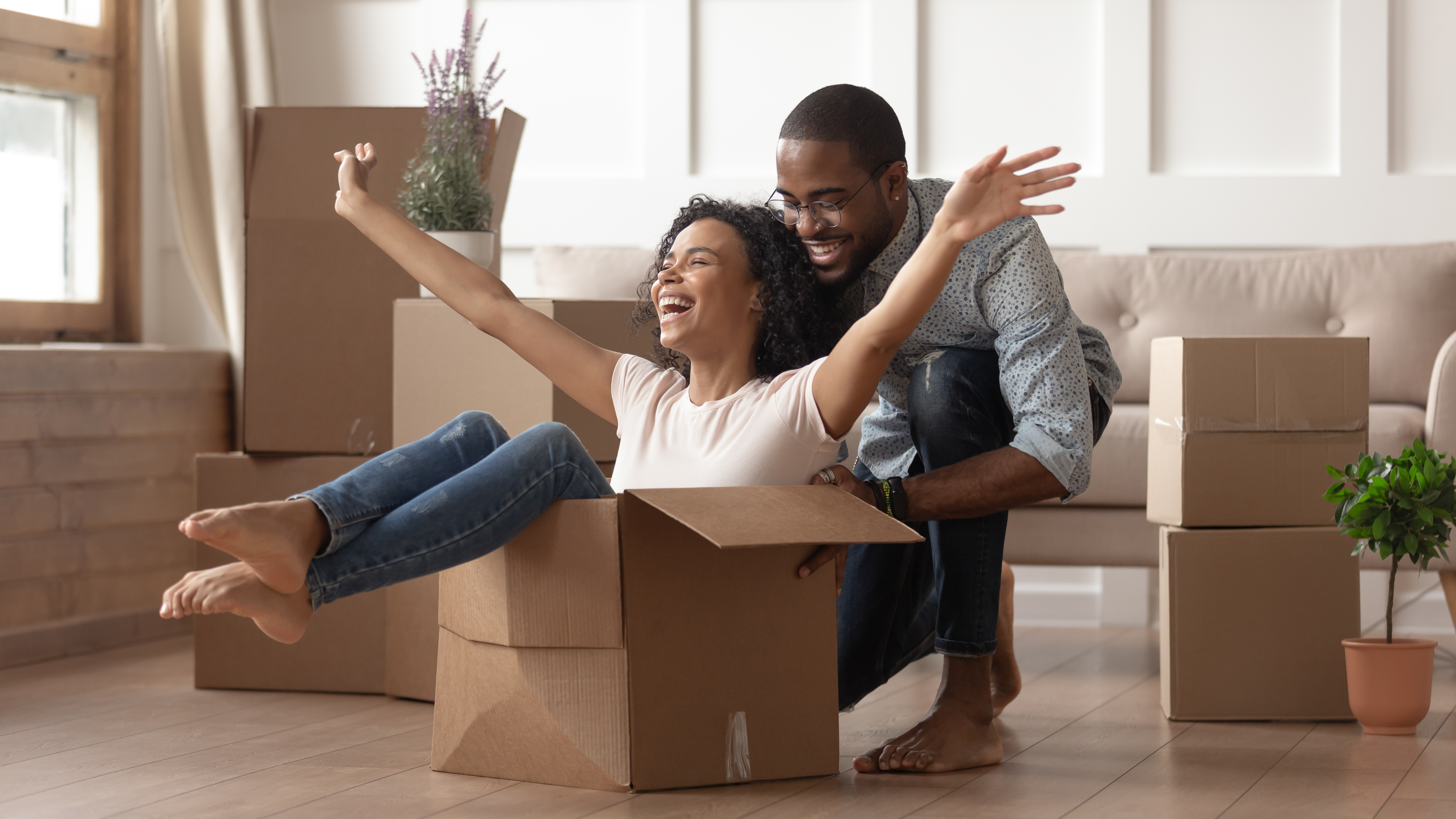 Man pushing woman in moving box