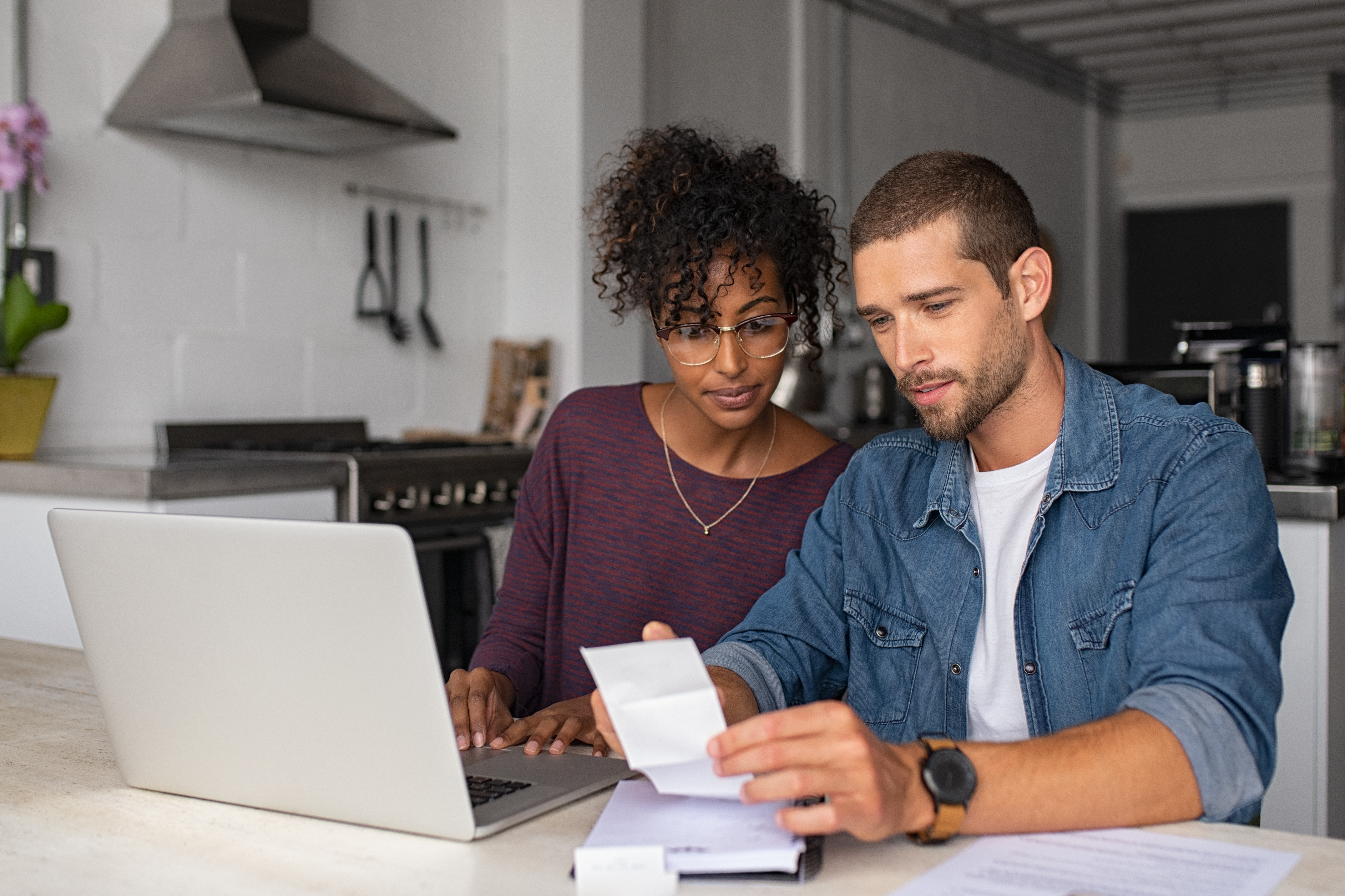 man and woman looking at receipts