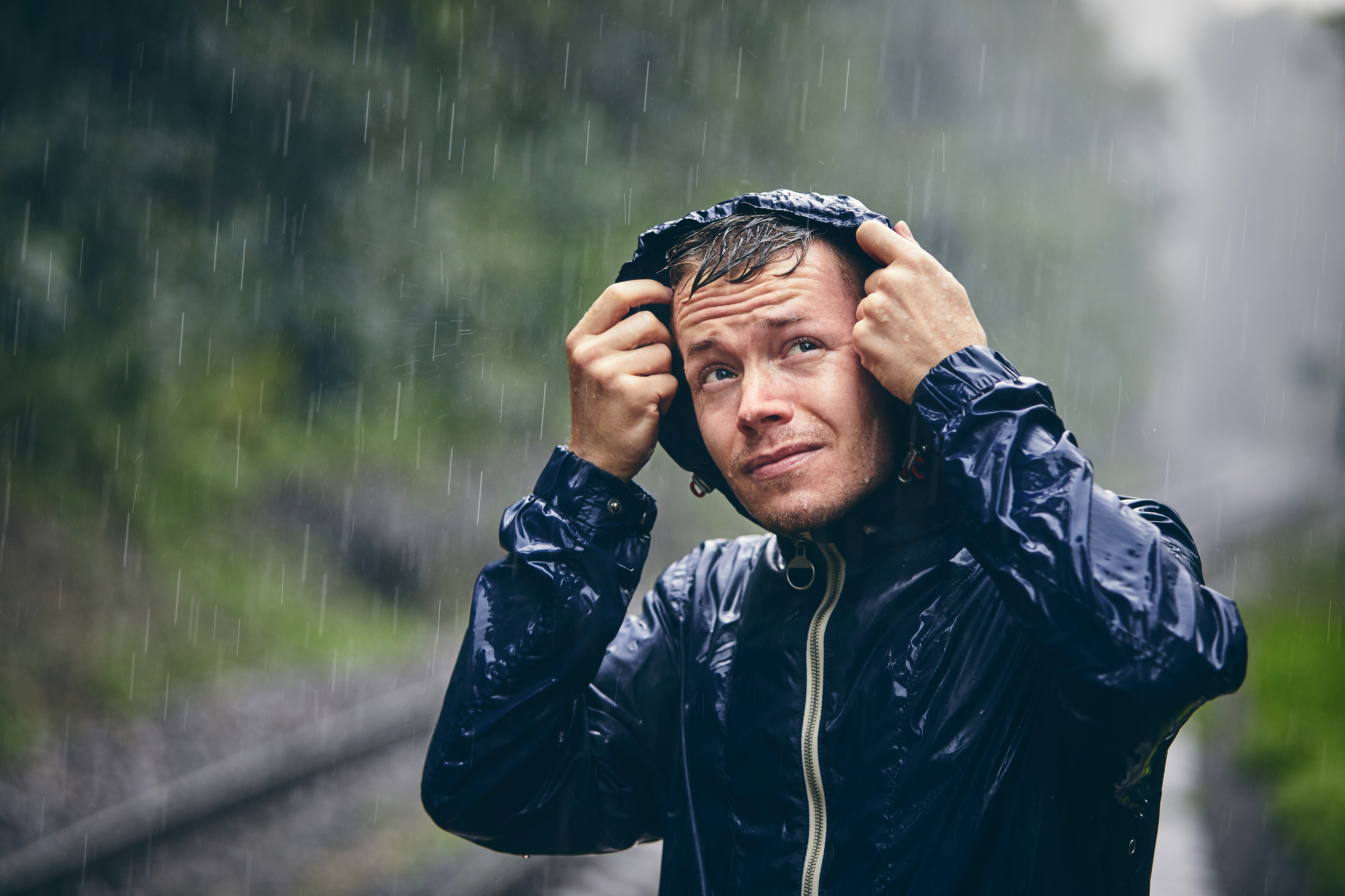 man standing in the rain