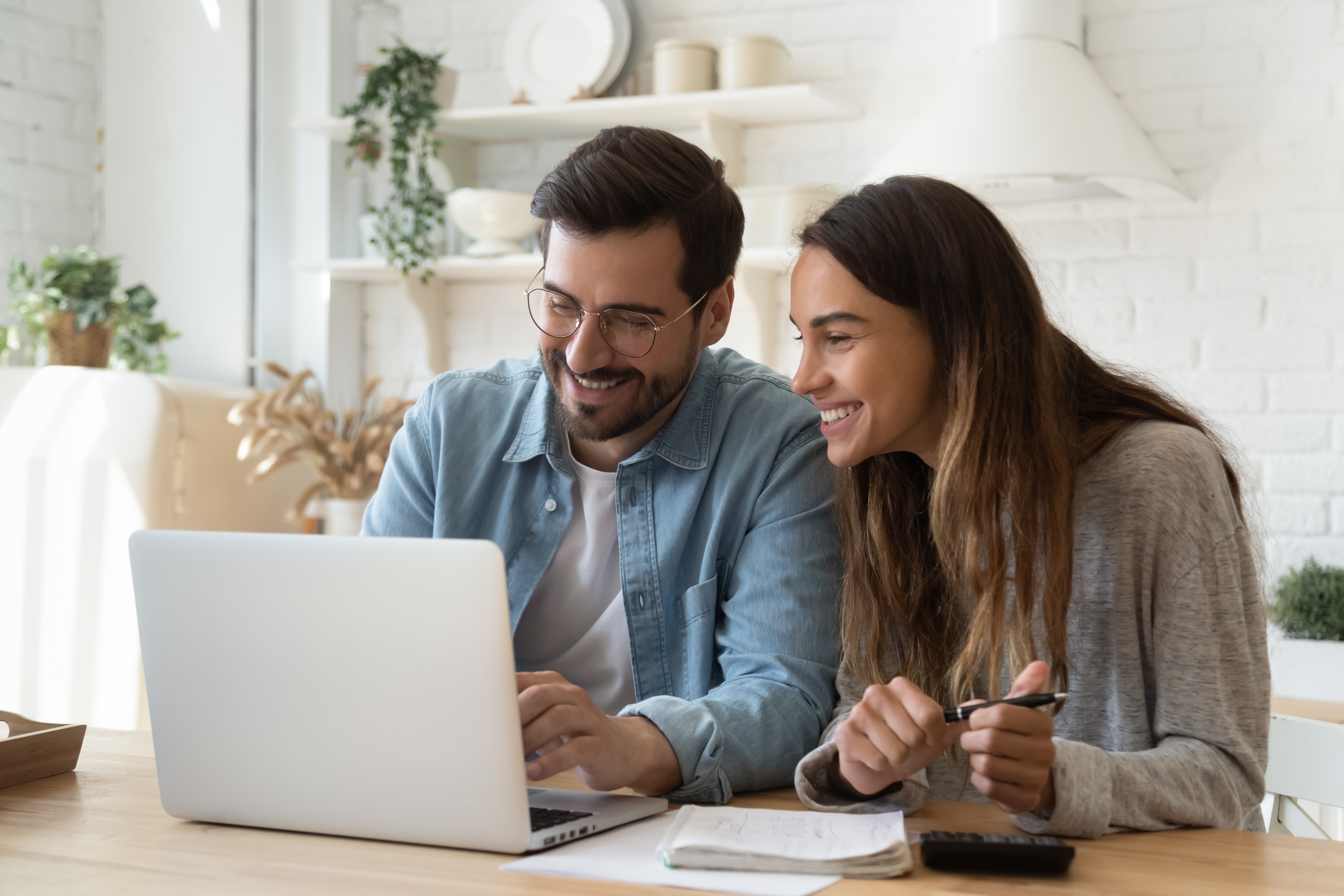 man and woman looking at computer