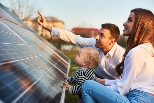 couple and child sitting on roof