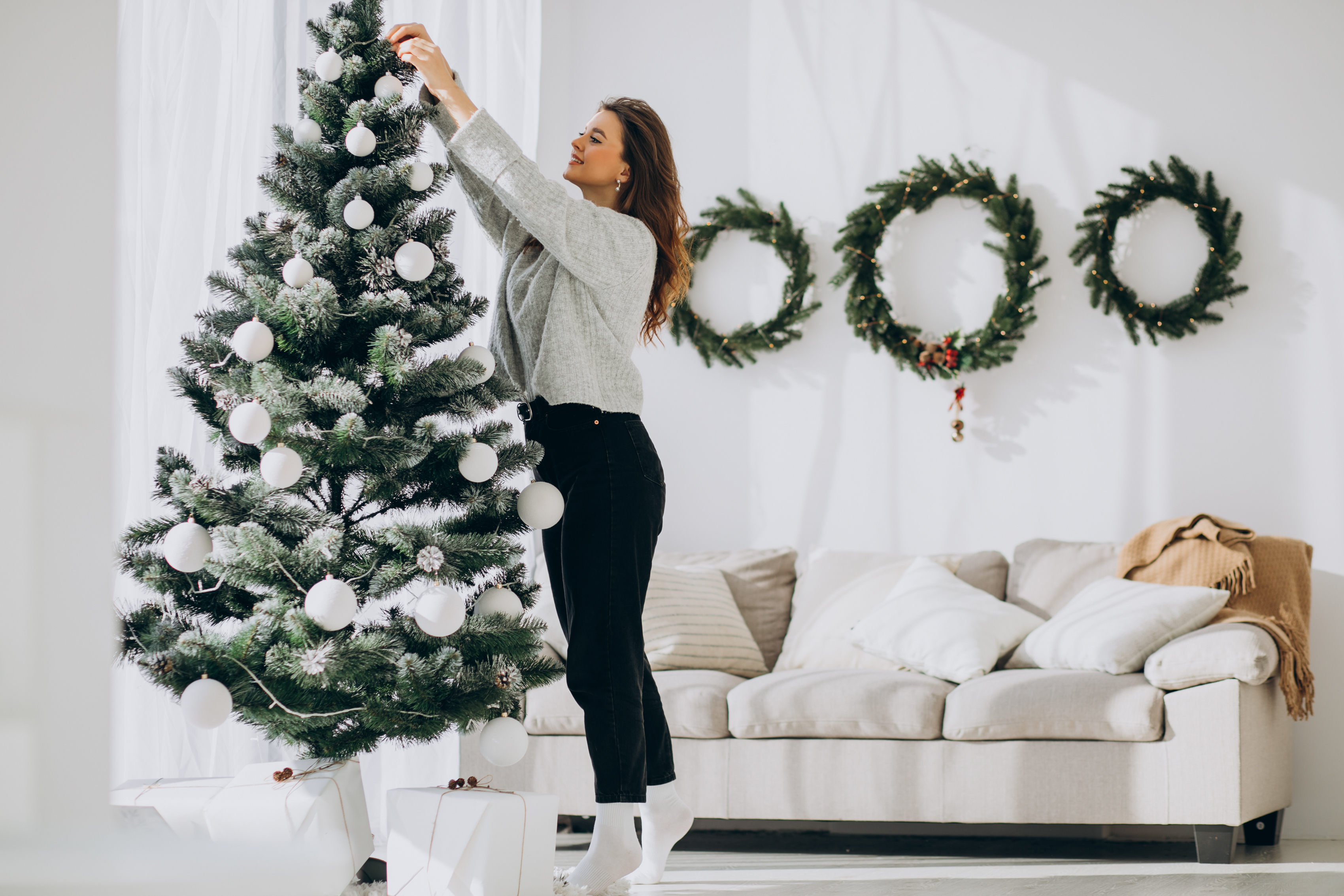 women decorating Christmas tree