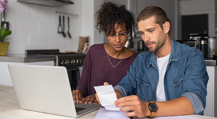 biracial couple looking over receipts